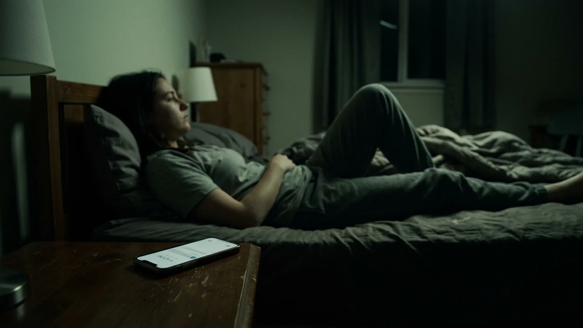Person in quiet room at night, posture of stillness